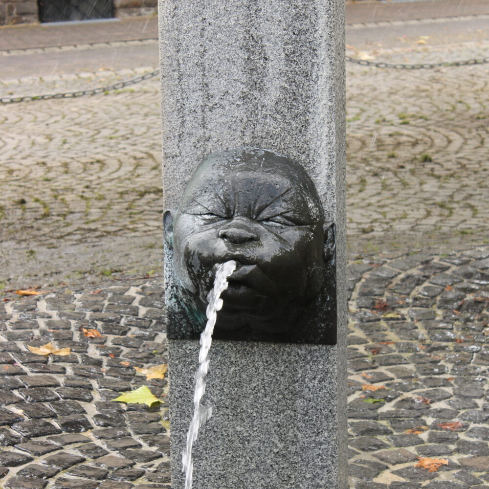 Wasserspeiende Köpfe an Steinsäulen sind die Markenzeichen des Narrenbrunnens