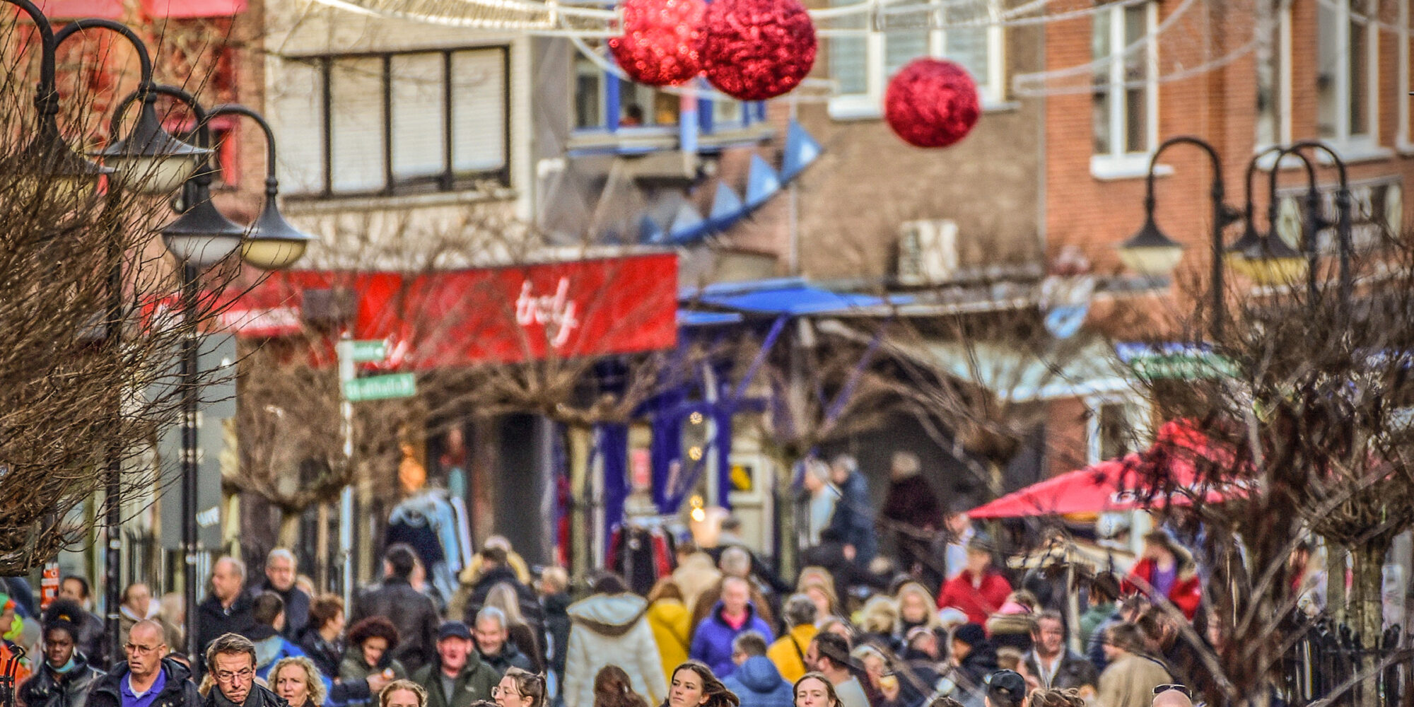 Viele Menschen in einer Innnestadt mit Weihnachtsbeleuchtung